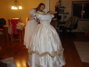 daughter putting the finishing touches on the historically accurate ballgown she designed